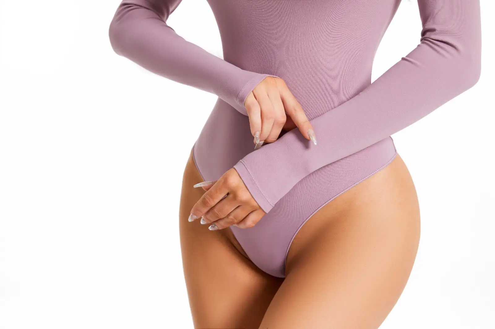 Close-up of torso of woman wearing a light pink long sleeve crew cut bodysuit