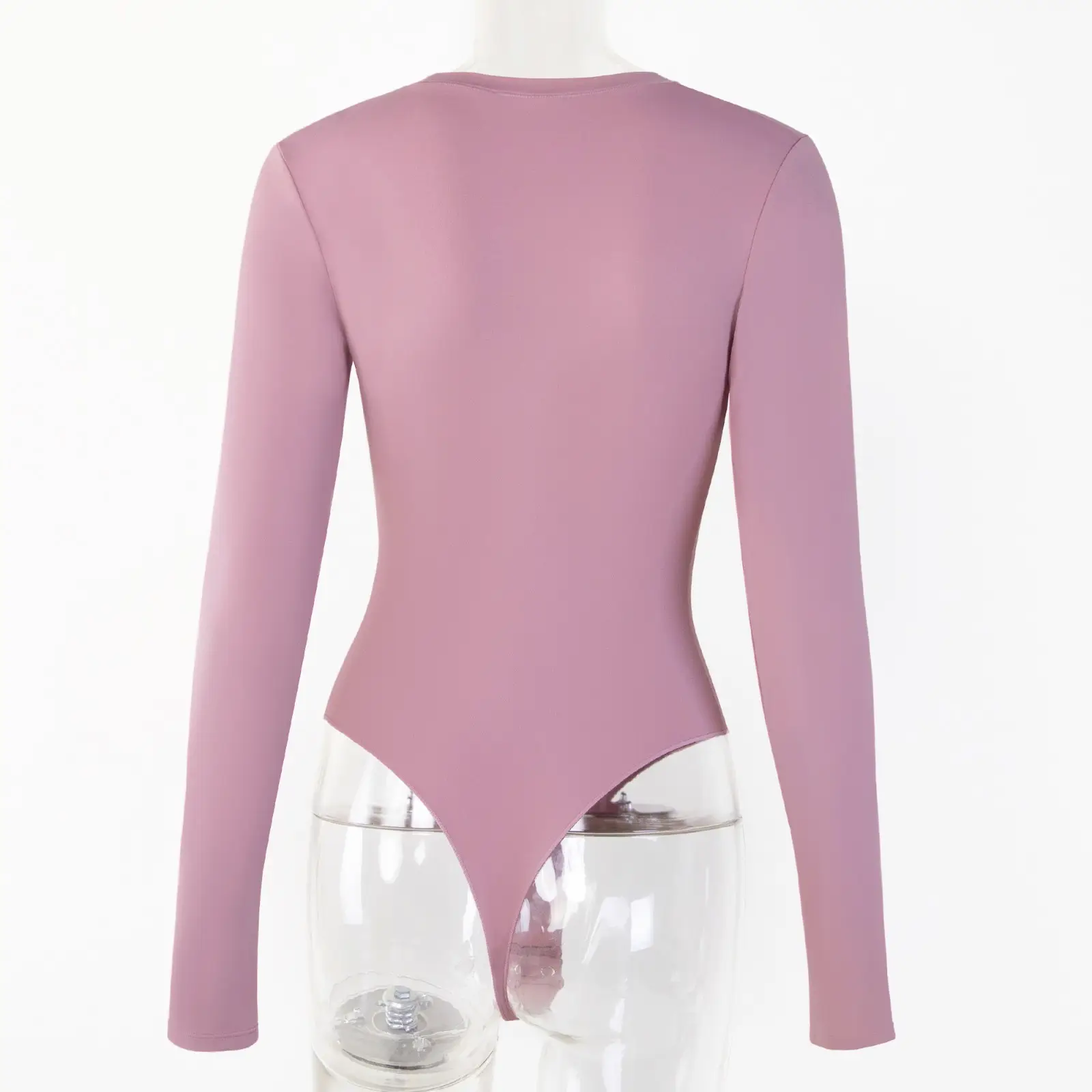 Transparent torso acrylic mannequin wearing a light pink long sleeve bodysuit with backside facing forward over a white background