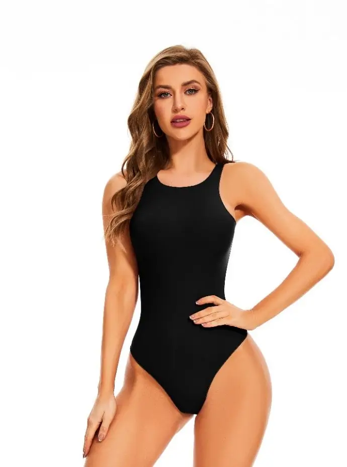 Woman wearing a sleeveless crew cut black bodysuit.