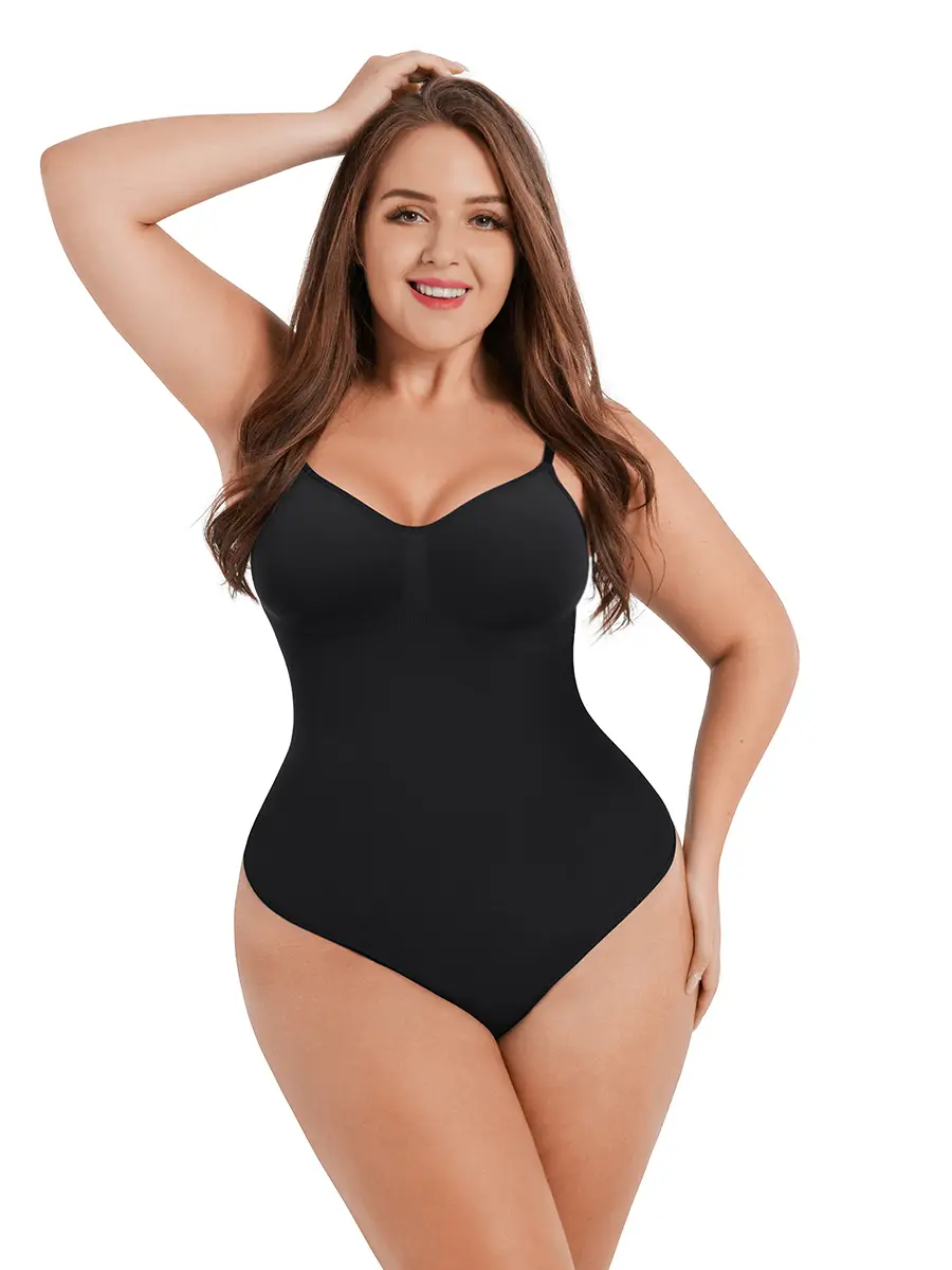 The image depicts a young woman wearing a black one-piece swimsuit, posing with her left hand raised to her head. She has ...
