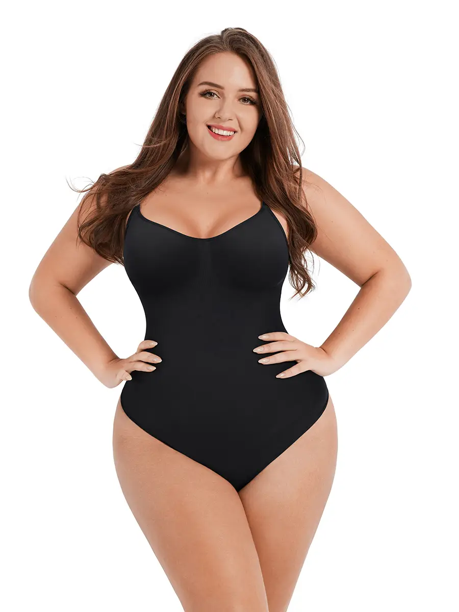 The image features a young woman with long brown hair and fair skin, wearing a black, form-fitting bodysuit with thin stra...